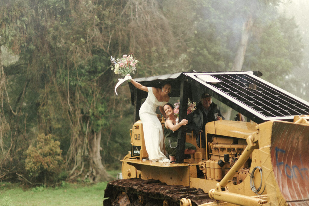 Bride comes into her wedding on a big old tractor at her family farm in Apiti. Wedding portrait captured by Eilish Burt Photography