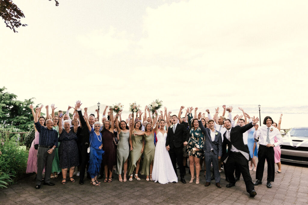 A very happy wedding party celebrate the bride and groom becoming husband and wife at Peppers On The Point. Captured by Eilish Burt Photography