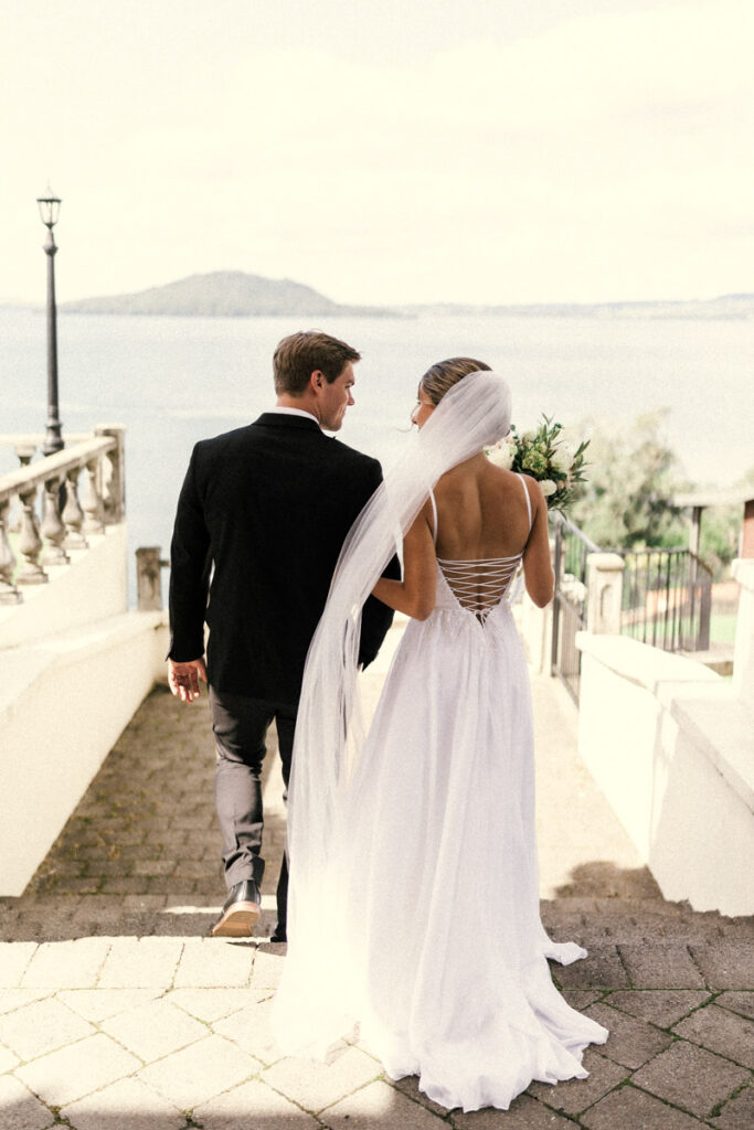 A European-feel wedding portrait of a couple walking down the beautiful steps at Peppers On The Point captured by Eilish Burt Photography