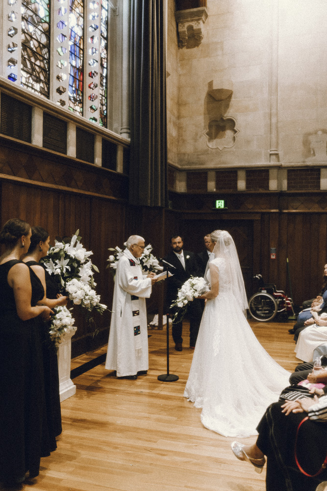 Bride and groom getting married in The Great Hall Art Centre in Christchurch