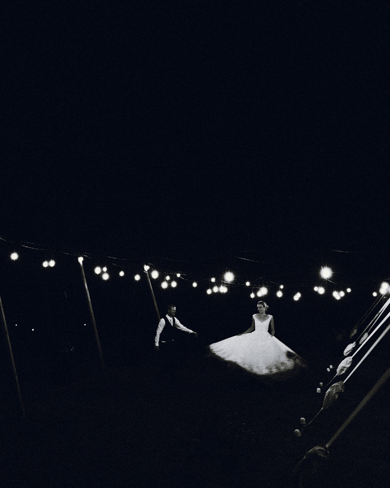 Husband and wife dance under the twinkling lights at their wedding in Christchurch captured by Eilish Burt Photography