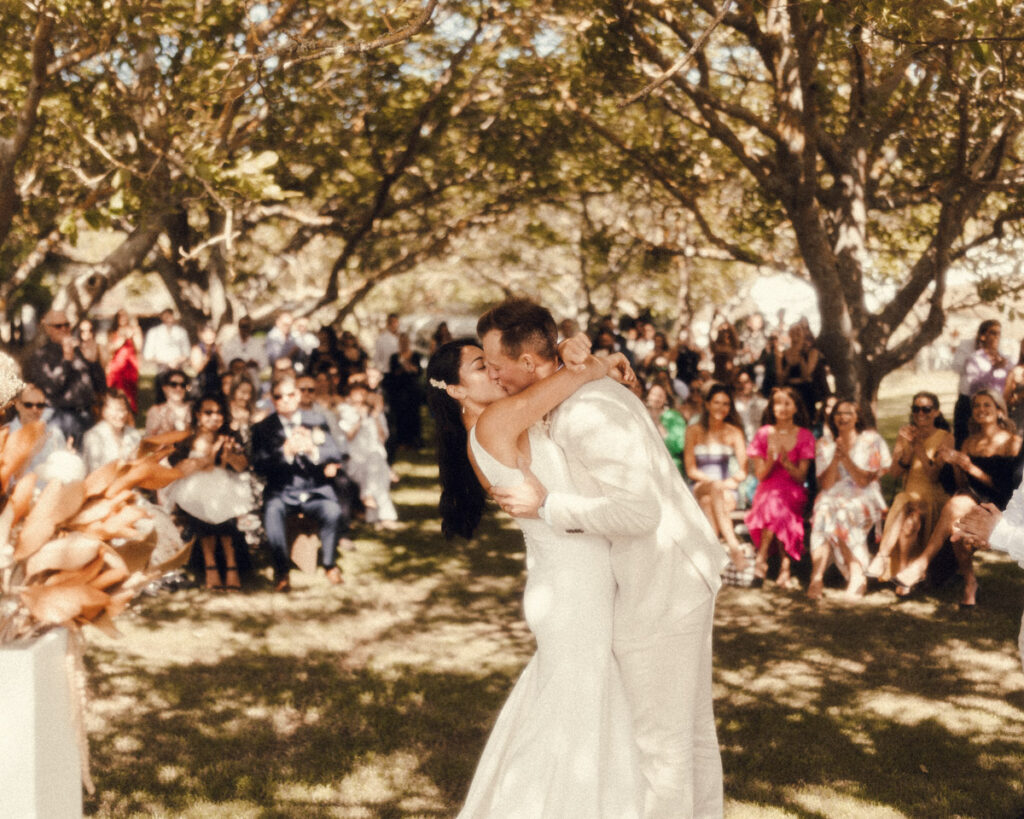 Bride and groom have their first kiss as husband and wife at Te Tumu Estate in Papamoa, Tauranga. Captured by Whakatane Wedding photographer, Eilish Burt Photography
