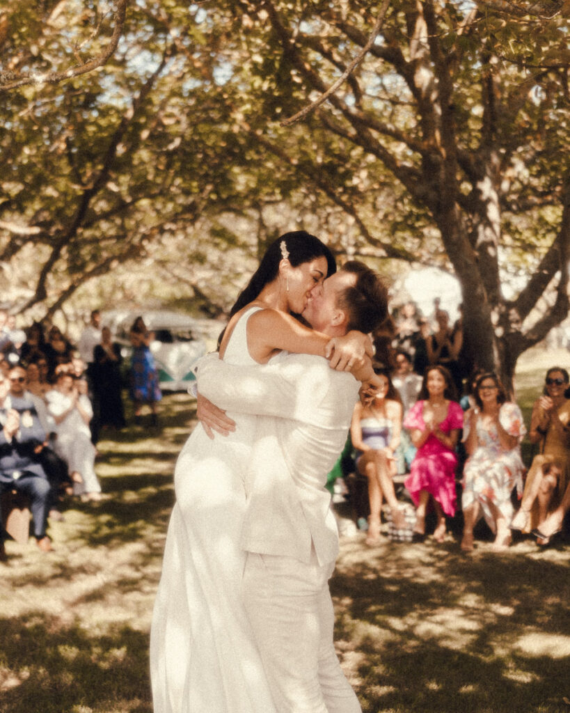 The happy couple share their first kiss as husband and wife at Te Tumu Estate in Papamoa, captured by Eilish Burt Photography