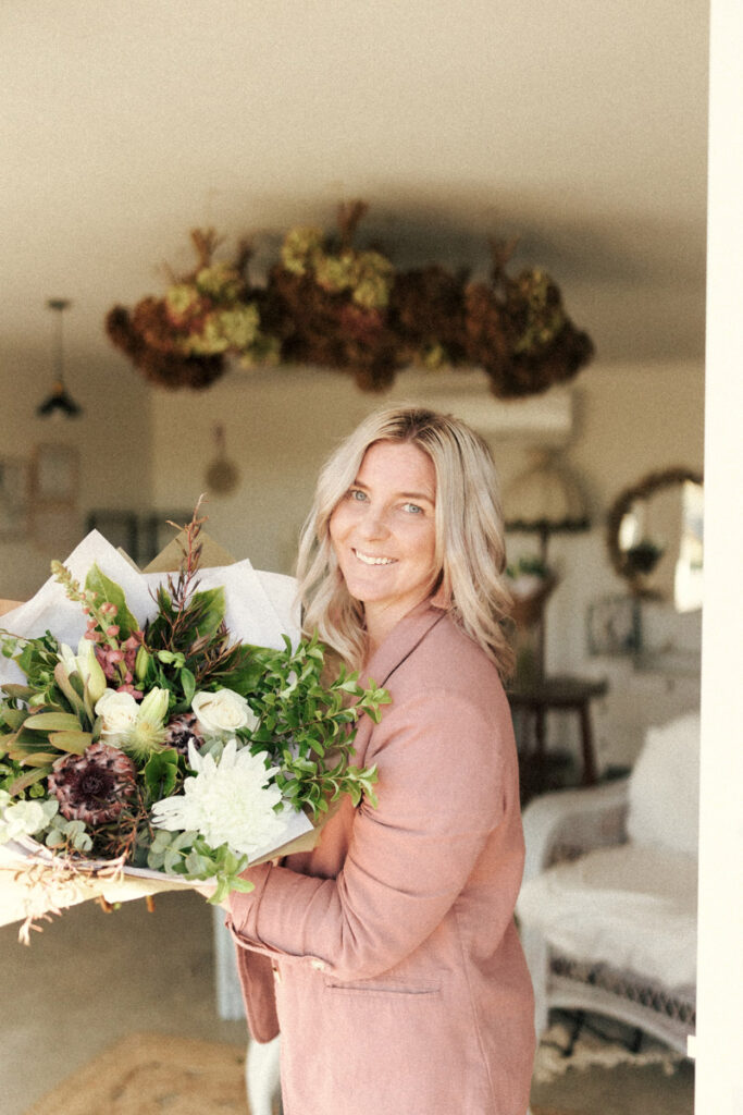 Emma from Sweet Stems holding one of her wedding bouquets. Captured by Eilish Burt Photography in Whakatane