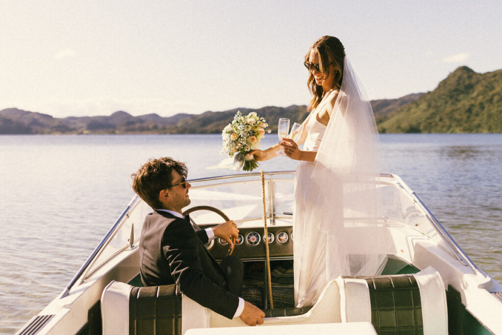 Bride and groom celebrate their marriage on a private boat ride in Lake Okareka, Rotorua
