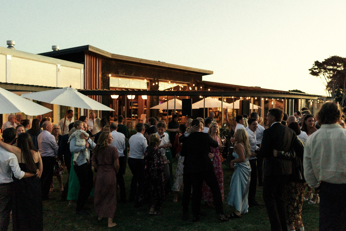 A photograph of a wedding party celebrating at The Batch Winery on Waiheke Island.