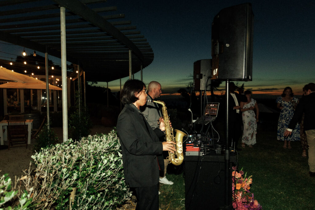 A saxophone player at The Batch Winery in Waiheke captured by wedding photographer Eilish Burt