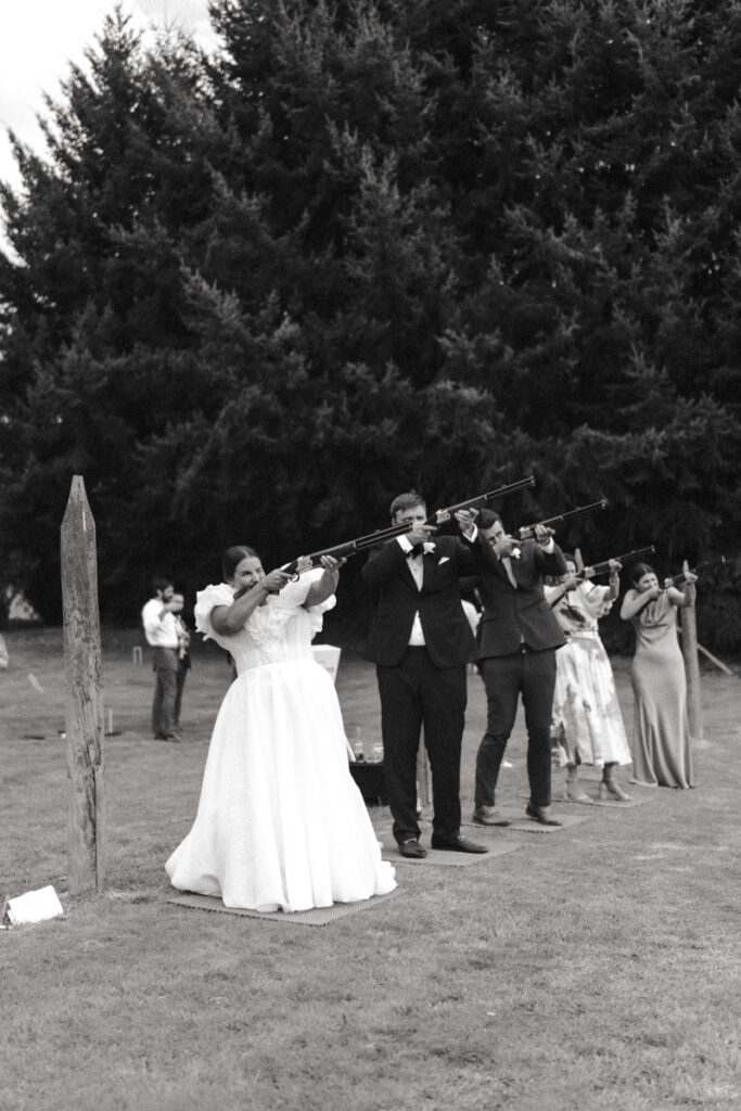 The bride and groom enjoy laser clay bird shooting at their wedding reception in Queenstown. Captured by Eilish Burt