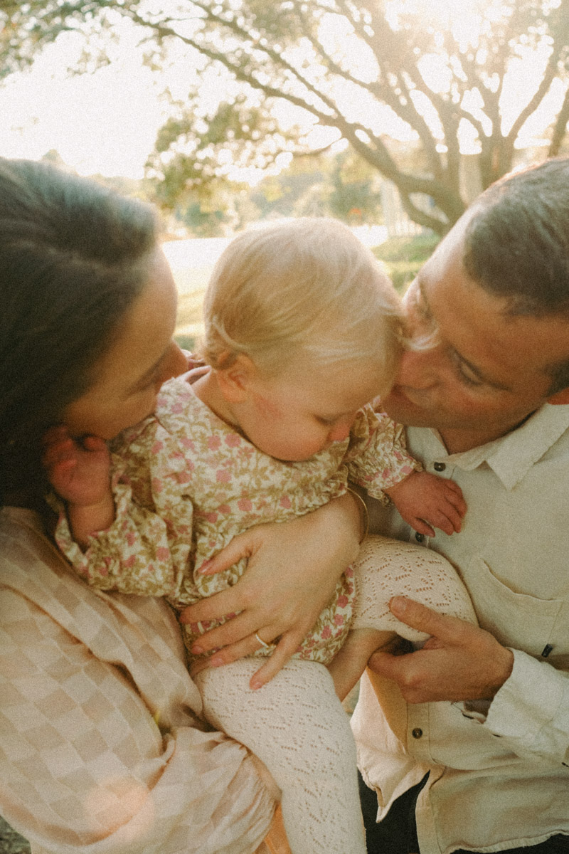 A family portrait of 3 at Ohope harbour, photographed by Eilish Burt.