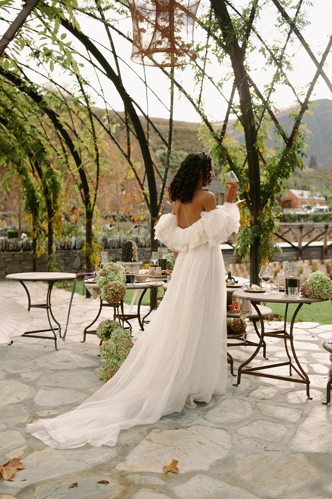 A beautiful bride, wearing a long white wedding gown at the Ayrburn venue in Queenstown. Captured by Eilish Burt Photography.