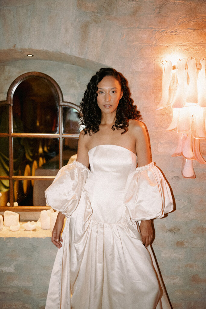 The bride is standing confidently in her pearl wedding gown. Photographed at the glamorous Ayrburn, Queenstown by Eilish Burt Photography.