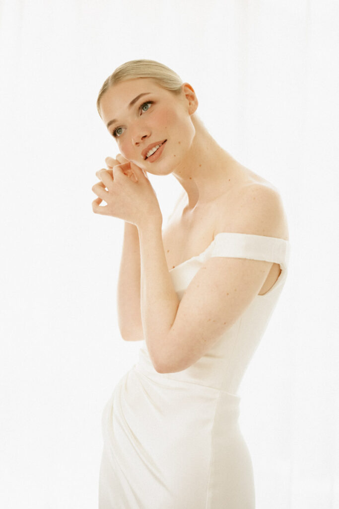 The bride puts her vintage pearl earrings in her ears before she walks down the aisle at Palm Creek Estate, Australia