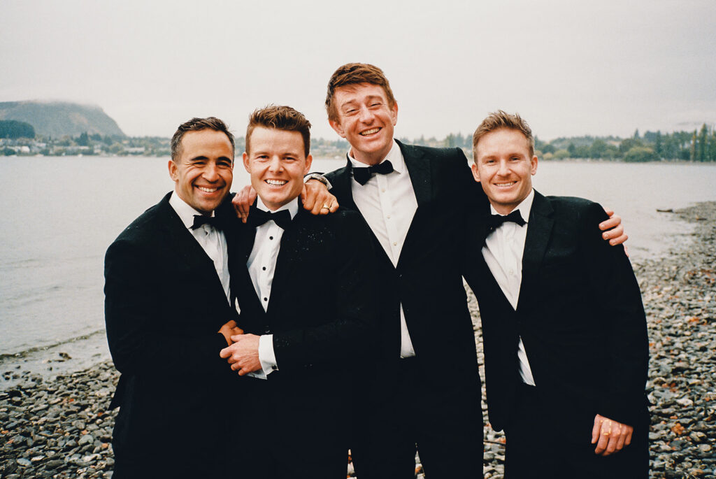 The groom and his groomsmen having a laugh at their Edgewater Wedding in Wanaka
